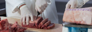 Cutting Meat With Gloves